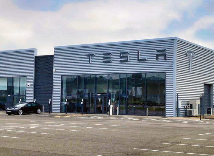 A grey building sits in a retail park with 'Tesla' written across the storefront. This is Tesla's new centre in Cork.