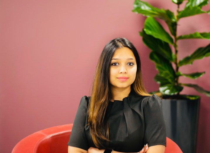 Headshot of Cozmotec founder and CEO Cuty Gupta, a young woman who is seated on a couch in an indoor space.