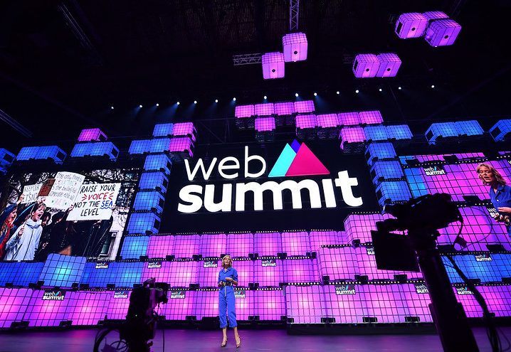 Katherine Maher talking on stage with a massive Web Summit logo behind her.