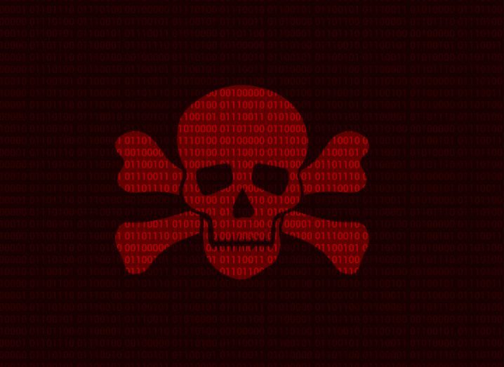A red skull with bones on either side of it, with code in the background. Used to represent the concept of ransomware.