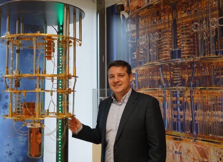 A man stands next to a model of a quantum computer. He is Dr Juan Bernabé-Moreno of IBM.