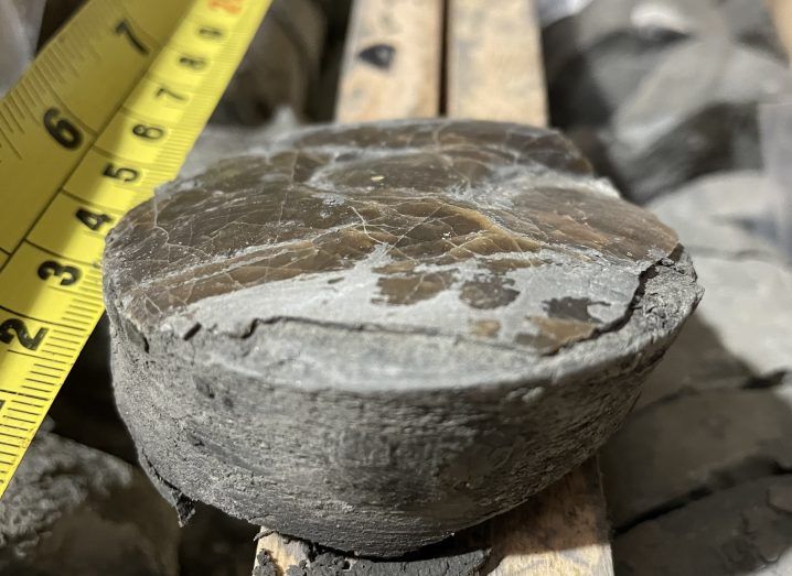 Close-up of a stone drilled from a seabed that helped the scientists conduct the study. A measuring tape is placed beside it.