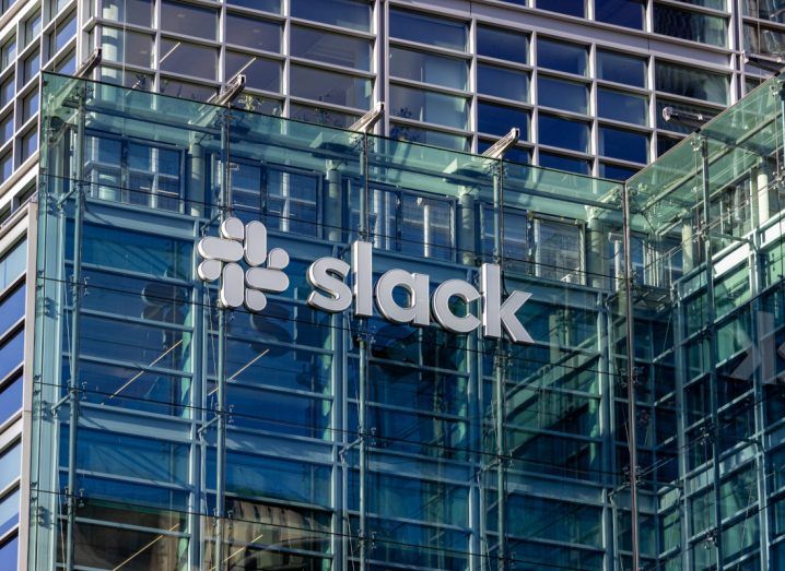 Slack logo on a glass building as seen from the street.