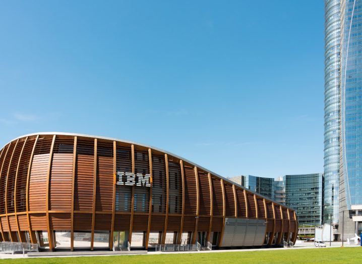 IBM logo on a building under a blue sky.