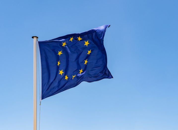 The EU flag with a blue sky in the background.