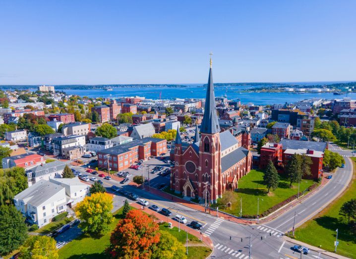 Aerial view of a city in Maine with a church in the centre.