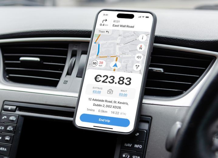 A phone in a car, showing a map and a price of 23 euro and 83 cents. Used to show the iCabbi integration with Google Fleet Engine.
