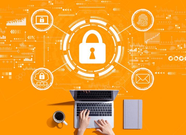 Internet network security concept with person working with a laptop against a bright orange background.