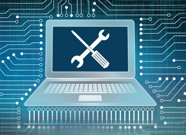 Illustration of a laptop with a screwdriver and spanner on its screen.