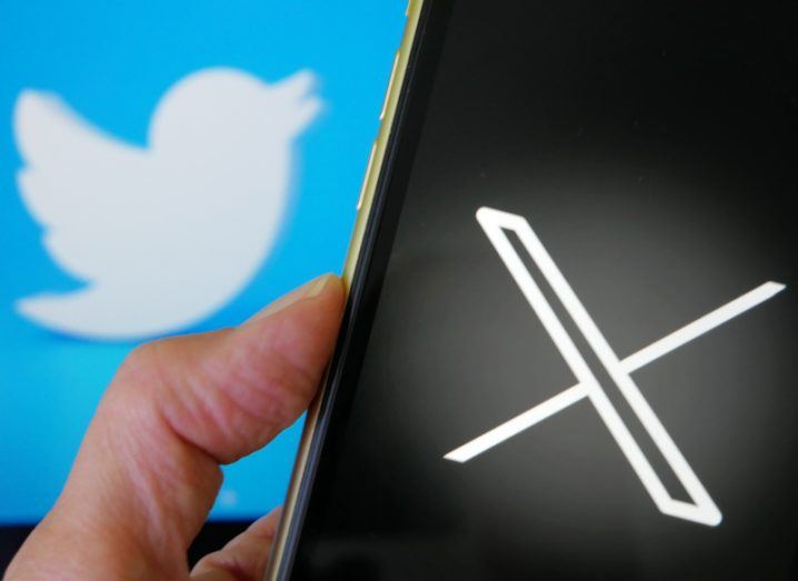 A smartphone with the X logo and the Twitter logo in the background.