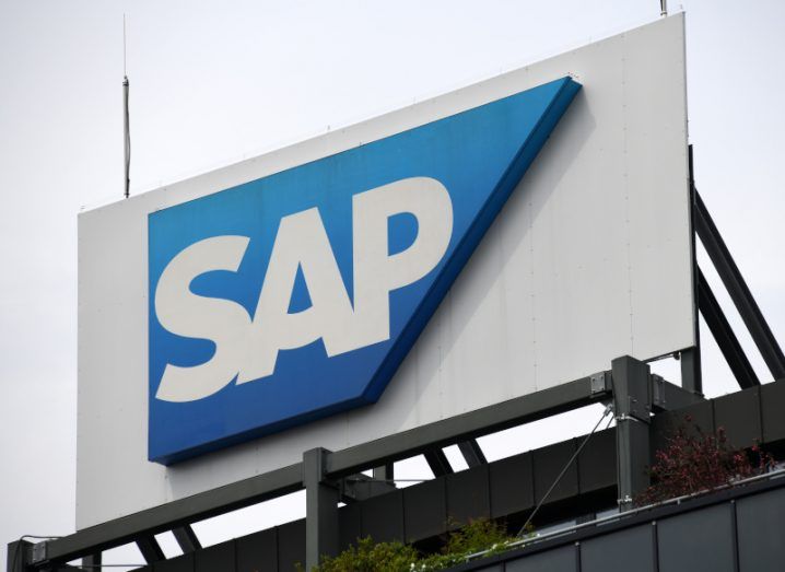 The SAP company logo on a white billboard on top of a building.