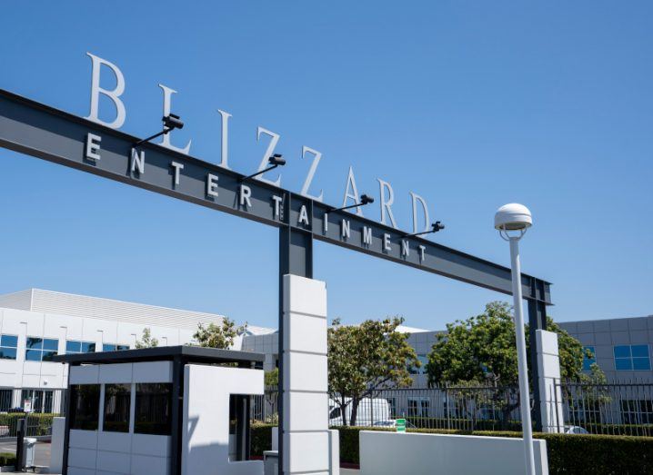 A large outdoor archway that says Blizzard Entertainment outside a large office campus on a sunny day.