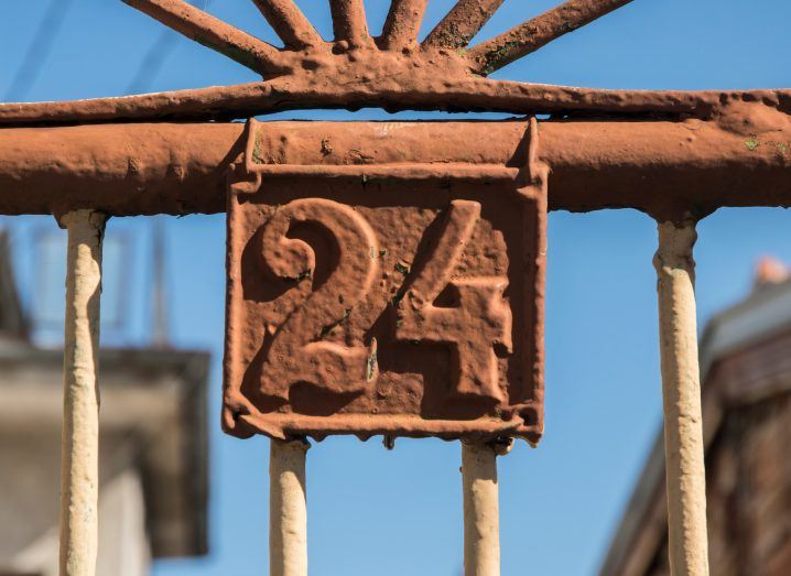 The number 24 in rusty iron on a gate.