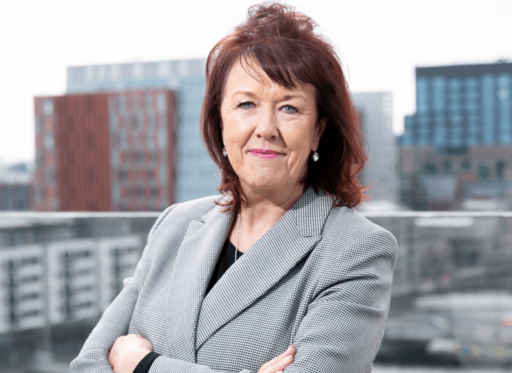 Headshot of Celene Craig in an outdoor space with the Dublin skyline visible behind her.