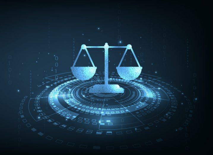 A digital graphic of blue legal scales hovering over a digital ring. It is a concept for internet law.