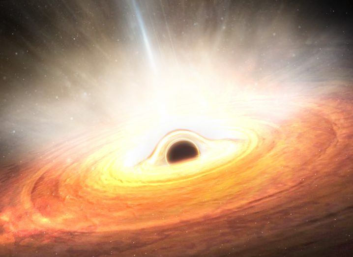A black hole in the centre of a large golden cloud of bright dust.