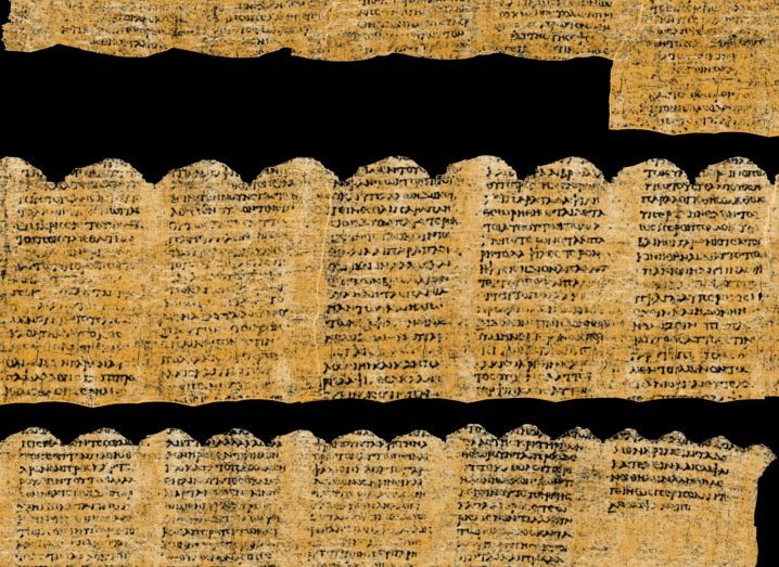 A scroll with Greek text written on it.