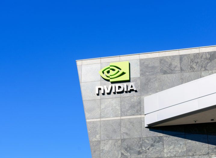 Nvidia logo on a building with a bright blue sky in the backdrop.