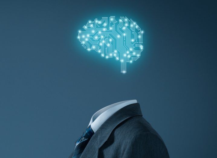 A digital brain hovers over a formal suit, symbolising business AI.