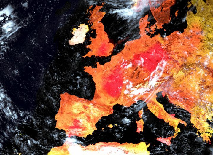 A satellite map of western Europe with the land deep shades of orange and red and the sea black to symbolise extreme heat.