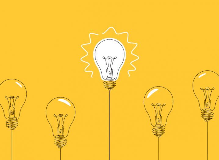 A cartoon drawing of a line of lightbulbs against a yellow background. One in the centre is white, showing that it is lit up.
