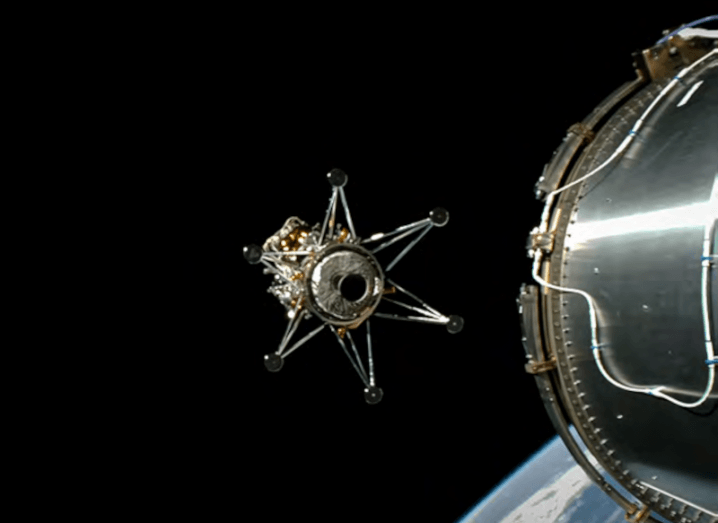 Image of a spacecraft detaching from another, with the Earth visible below and space visible in the background.