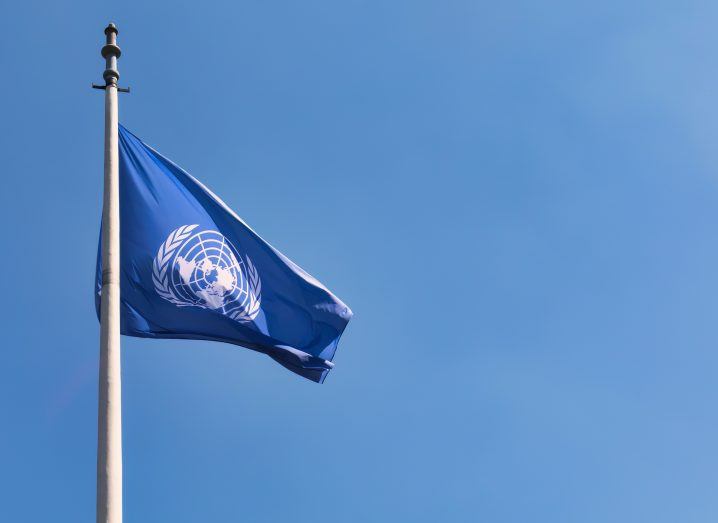 UN flag in the backdrop of a blue sky.