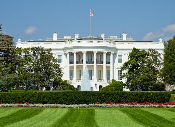 The US White House with trees and green grass in front of it.