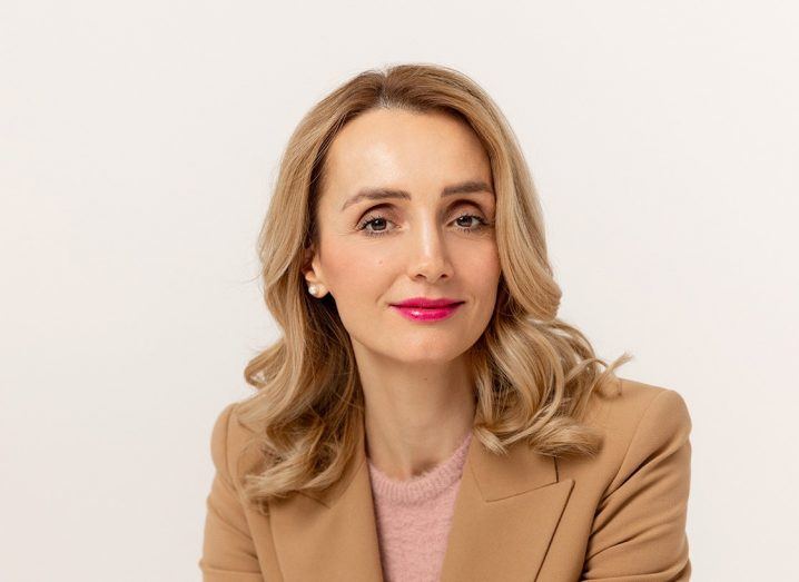 Headshot of Legitify CEO Aida Lutaj wearing a beige suit.