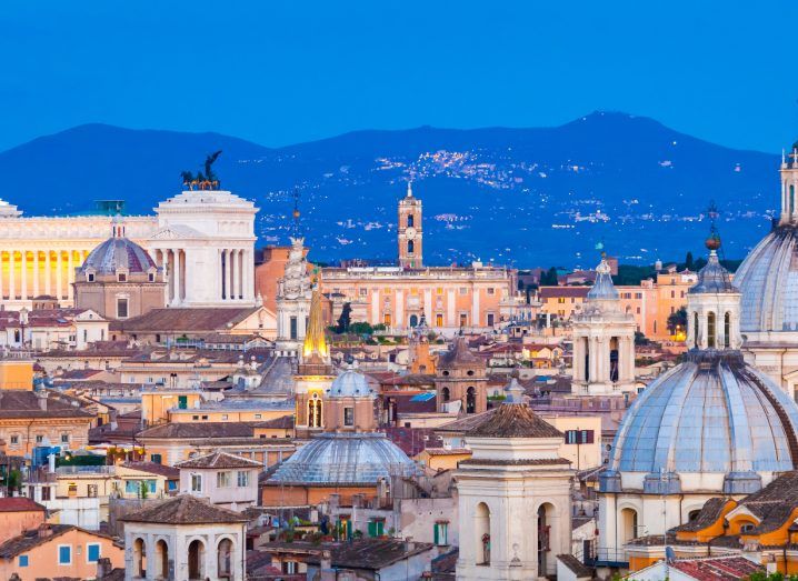 Photo of the skyline of Rome in what appears to be the evening.