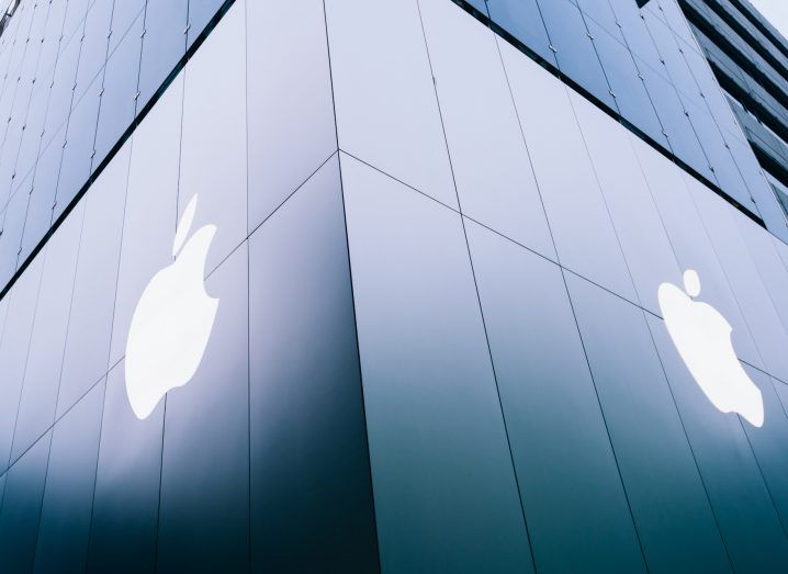 Apple logos on two sides of the corner of a building.