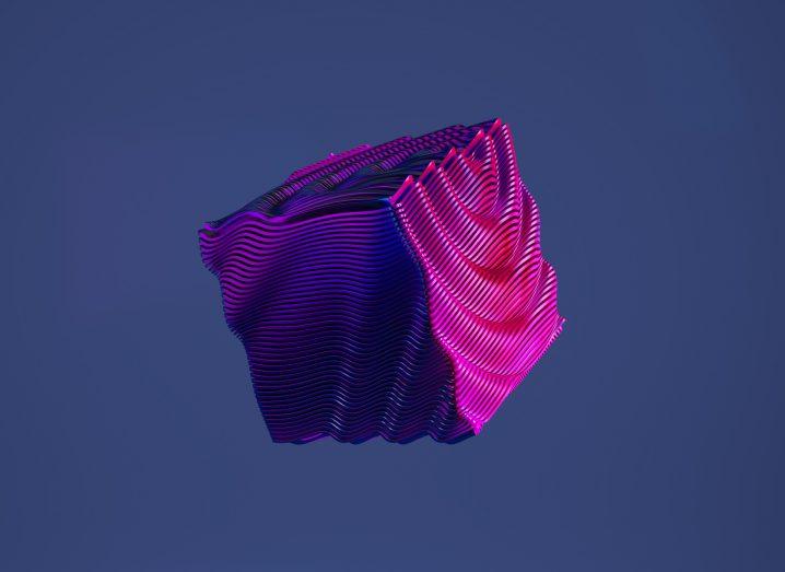 A pink 3D cube-shaped object floating in a navy blue background.