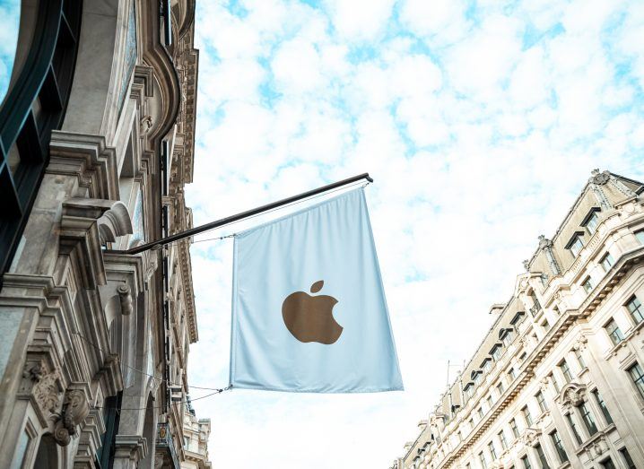A flag on a street in Europe with the Apple logo on it.