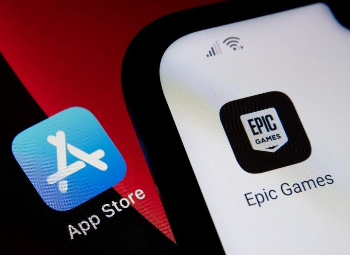 Phone showing the Epic Games icon placed on top of a screen that show the Apple App Store icon.