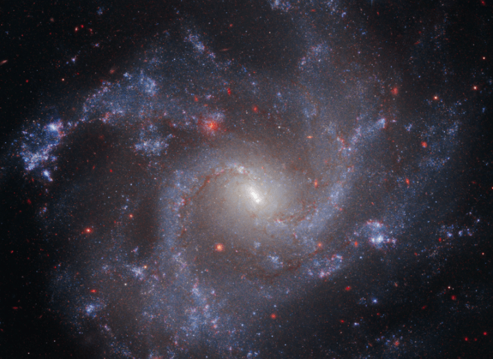 An image of a distant galaxy, taken from readings of both the Hubble and James Webb Space Telescopes.