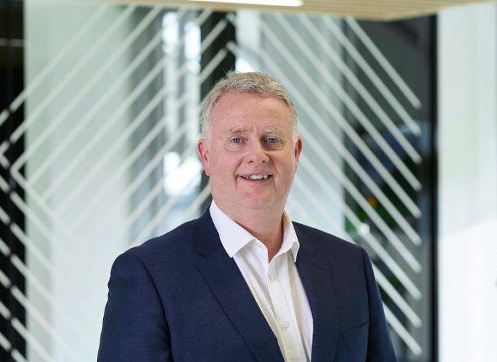 An image of EY employee Sean Casey standing in front of a window.