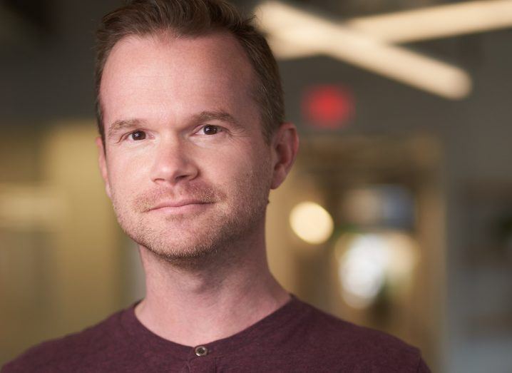 Headshot of DBT Labs CEO Tristan Handy in an office space with a blurred background.