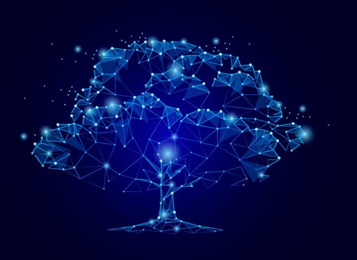 A digital illustration of a tree made of blue circuits. Used for the concept of tech and sustainability being connected.