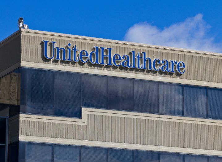 The UnitedHealth company logo on the top of a building.