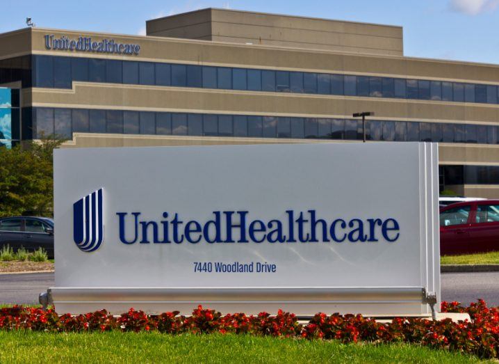 The UnitedHealth logo on a sign in front of a building.