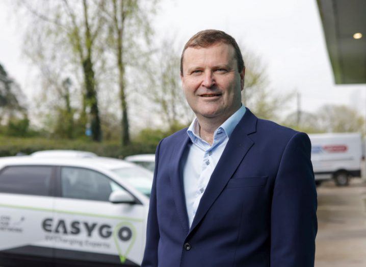 Oliver Chatten standing in front of a car with the EasyGo logo on it.