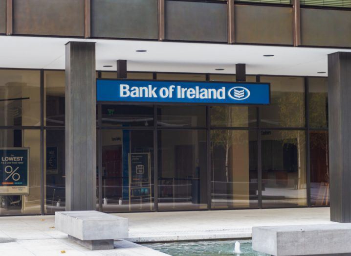 A front view of a Bank of Ireland branch in Dublin, with a sign displaying the bank's name in front of glass doors.