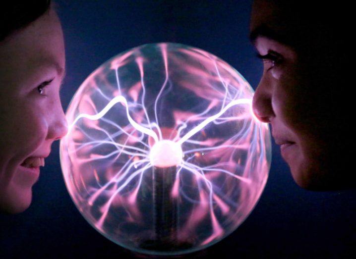Two girls looking at a plasma globe. Used for the context of the BT Young Scientist and Technology Exhibition, or BTYSTE.