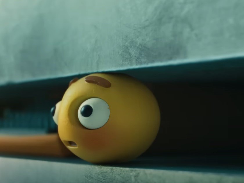 Screenshot of an Apple iPad ad video showing a smiley ball being crushed by a hydraulic press.
